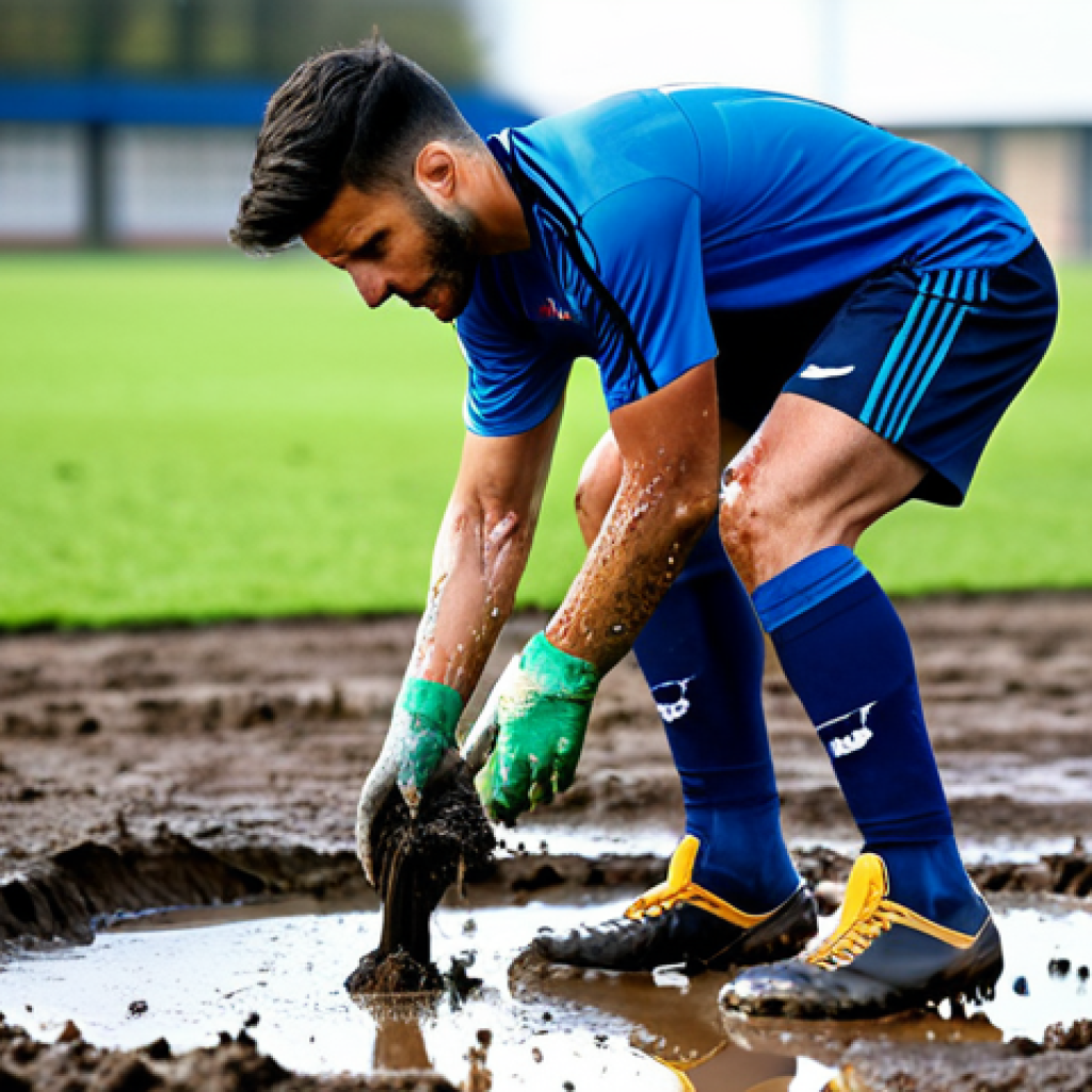 A male football player, fully clothed in a modest and professional football kit, carefully knocking excess mud off his cleats after a match. He is standing near a water tap on the edge of a clean football pitch. His hands are well-formed and naturally posed as he performs this routine cleaning. The scene is well-lit, capturing the texture of the mud and the boots. Safe for work, appropriate content, fully clothed, professional, perfect anatomy, correct proportions, natural body proportions, natural pose, professional photography, high quality, realistic.